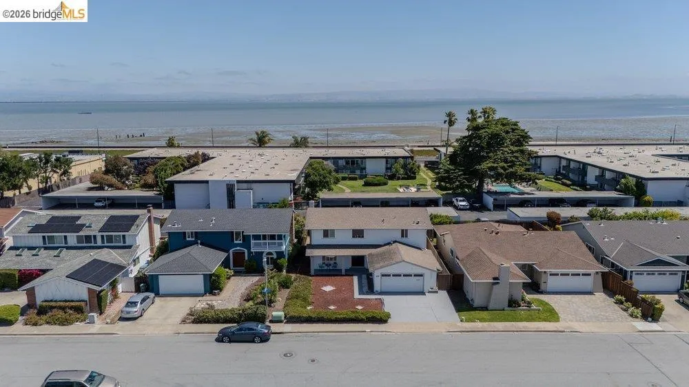 Residential properties featuring various architectural styles, paved driveways, and landscaped front yards