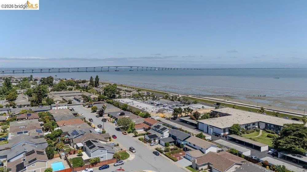Aerial perspective showcasing a coastal neighborhood with residential properties