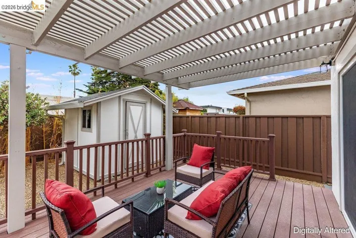 Spacious outdoor deck with a slatted pergola overhead