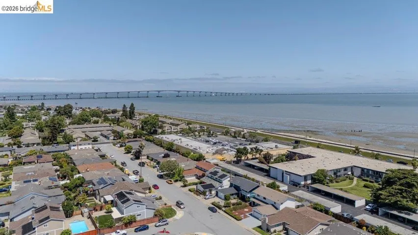 Aerial perspective showcasing a coastal neighborhood with residential properties