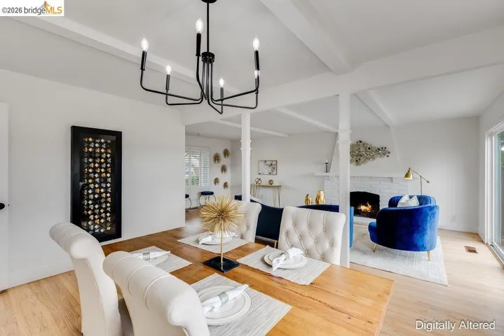 Dining area with wood-finish flooring and a black chandelier