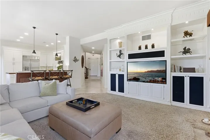 Inviting living space featuring a fireplace and seamless indoor-outdoor flow to the backyard entertaining areas.