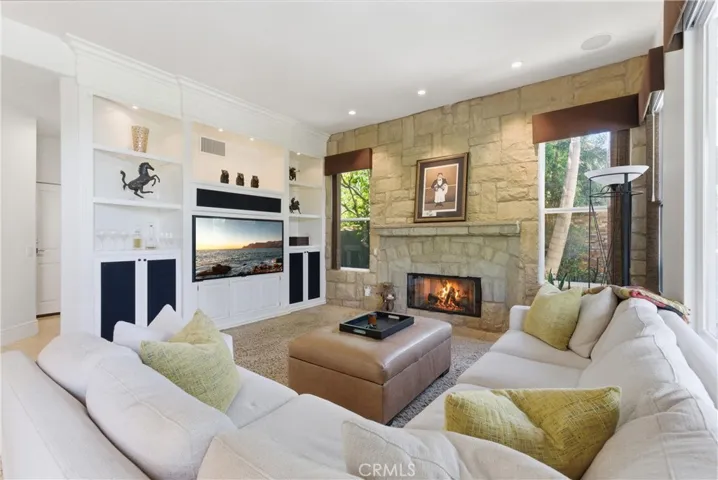 Inviting living space featuring a fireplace and seamless indoor-outdoor flow to the backyard entertaining areas
