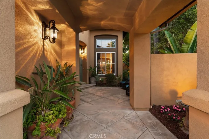 Welcoming covered entry with an inviting courtyard setting