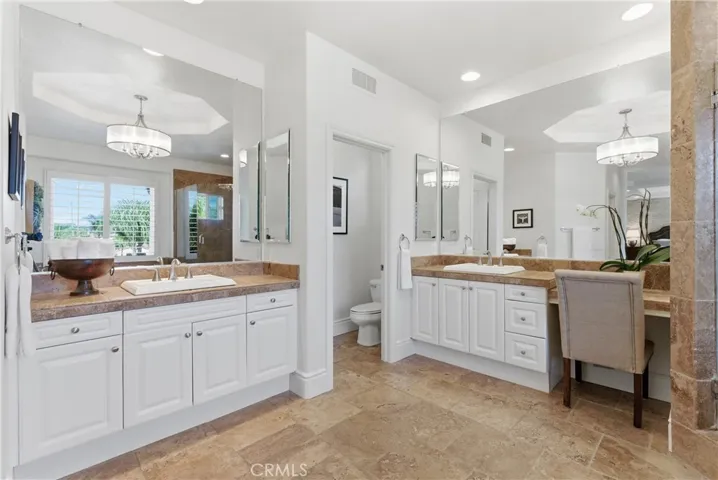 Spa-inspired primary bathroom with dual vanities, a soaking tub, and oversized walk-in shower
