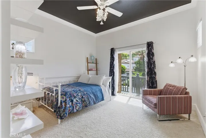 Secondary bedroom featuring a balcony, and abundant natural light