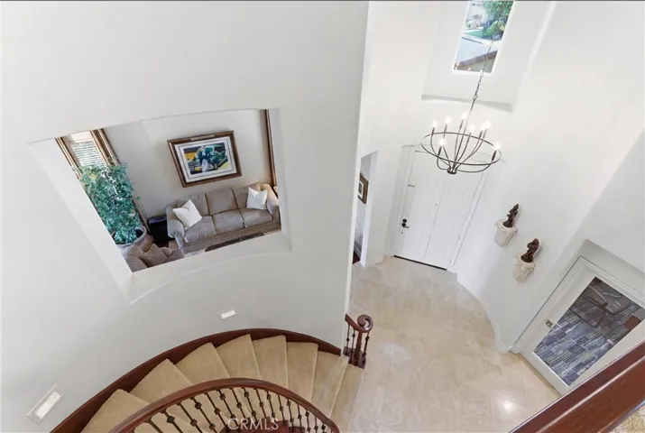 Dramatic entry with soaring ceilings and elegant staircase detailing