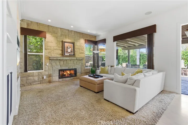 Inviting living space featuring a fireplace and seamless indoor-outdoor flow to the backyard entertaining areas