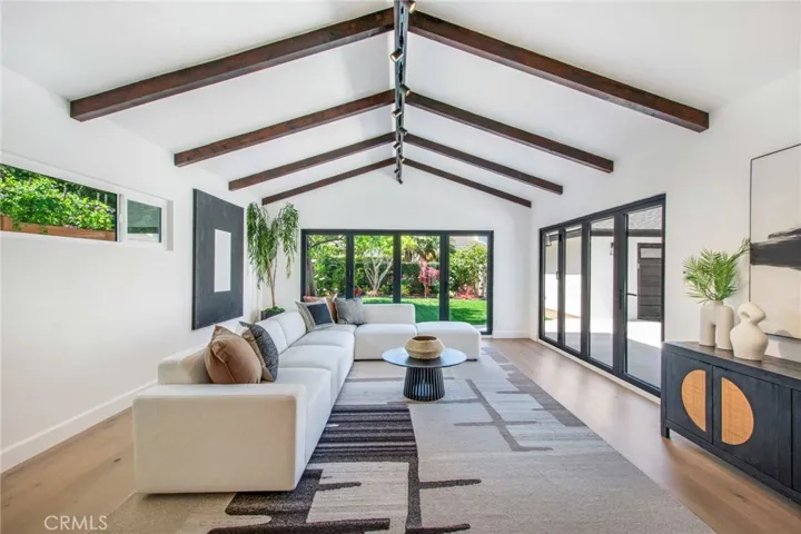 Great room flows seamlessly to the rear yard through new bi-fold glass doors | 305 Robinhood Ln., Eastside Costa Mesa 92627