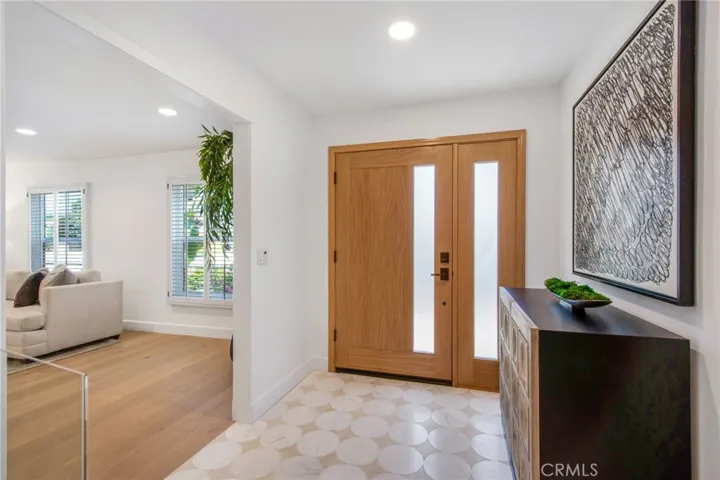 Marble penny-tile foyer opens to wide-plank European white oak floors | 305 Robinhood Ln., Eastside Costa Mesa 92627