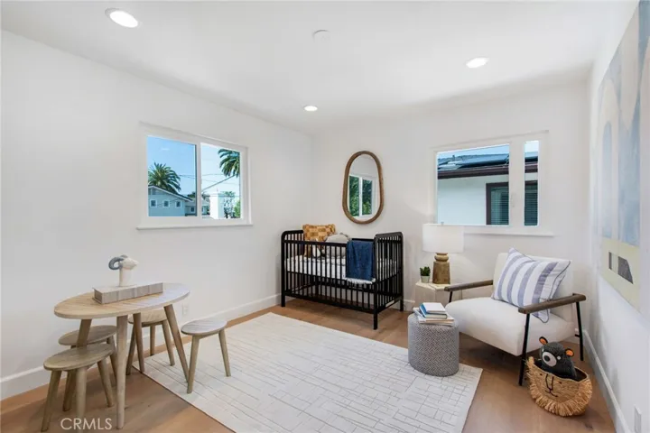 Versatile upstairs bedroom currently styled as a nursery | 305 Robinhood Ln., Eastside Costa Mesa 92627
