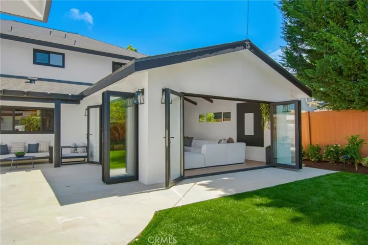 Indoor-outdoor flow with great room bi-fold doors fully retracted | 305 Robinhood Ln., Eastside Costa Mesa 92627