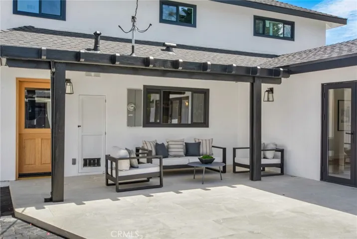 Covered patio under steel-beam pergola, tailored for entertaining | 305 Robinhood Ln., Eastside Costa Mesa 92627