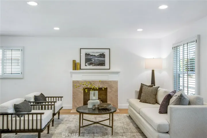 Formal living room anchored by a marble-surround fireplace | 305 Robinhood Ln., Eastside Costa Mesa 92627