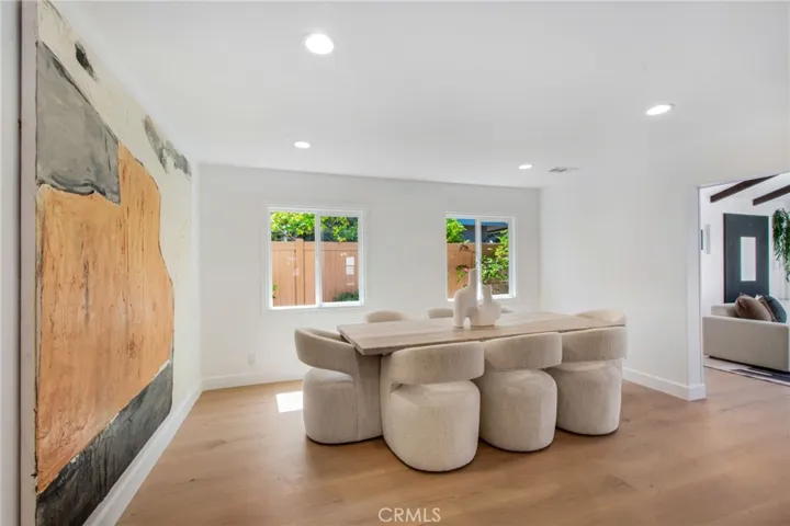 Formal dining room with an inviting long table for entertaining | 305 Robinhood Ln., Eastside Costa Mesa 92627