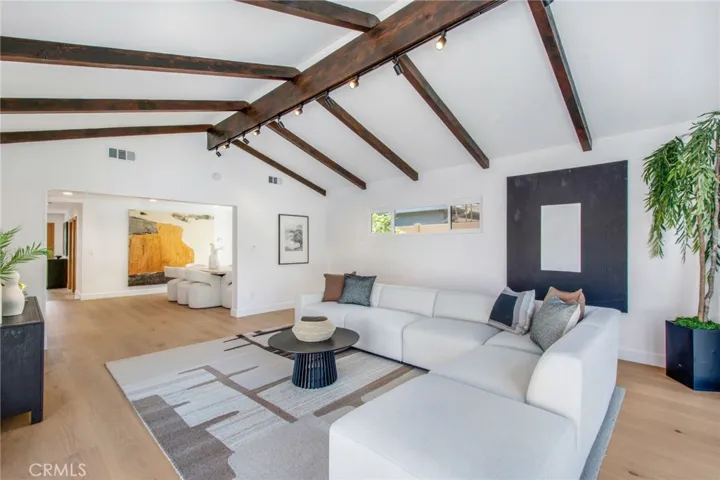 Great room with restored exposed timber beams and vaulted ceilings looking back towards the kitchen and dining areas| 305 Robinhood Ln., Eastside Costa Mesa 92627