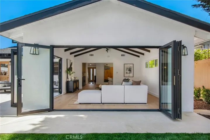 Vaulted great room opens fully to the covered patio through new bi-fold glass doors | 305 Robinhood Ln., Eastside Costa Mesa 92627