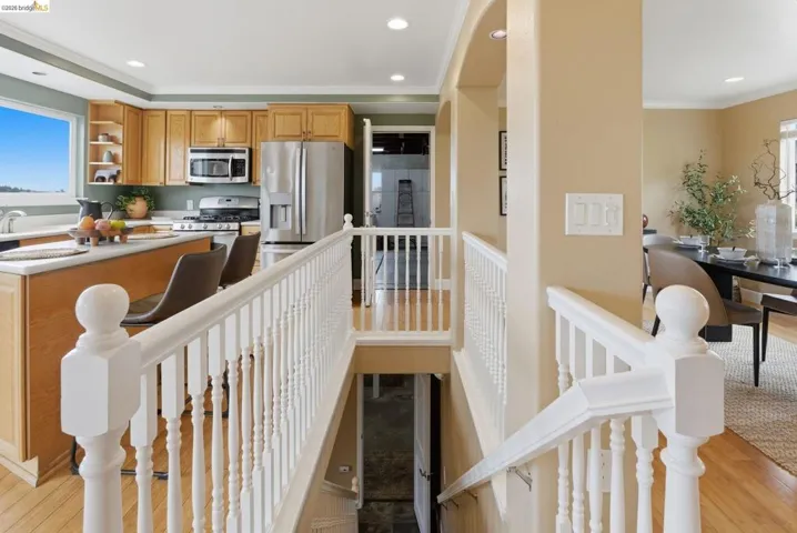 Stairway featuring white balusters and newel posts