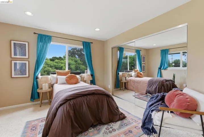 Bedroom featuring light-toned walls, recessed lighting, and carpet flooring