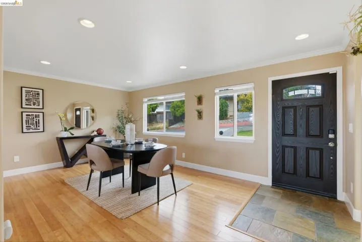 Entryway featuring slate tile flooring and a paneled door with an arched transom window