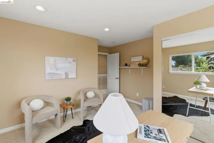 Carpeted room featuring recessed lighting, a built-in wall shelf, and a white interior door