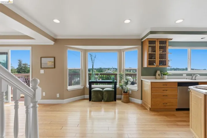 Hardwood-finish flooring throughout, featuring a bay window, recessed lighting, and crown molding