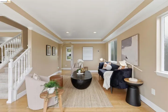 Living area featuring light wood-finish flooring, recessed lighting, and crown molding