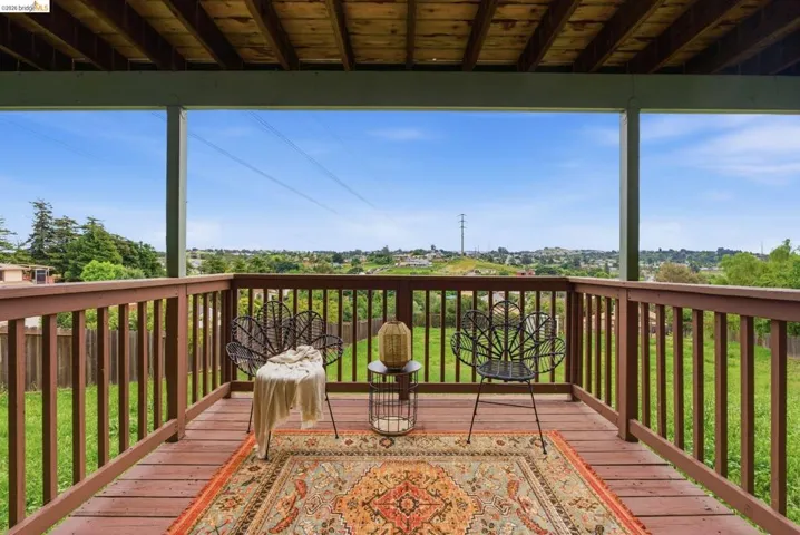 Expansive wooden deck with railing, offering open-air outdoor living