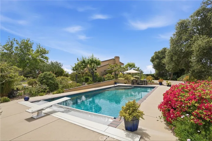 Protected and private pool framed with patio