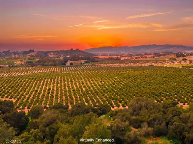 Sunset views over fields, hills, and the coast