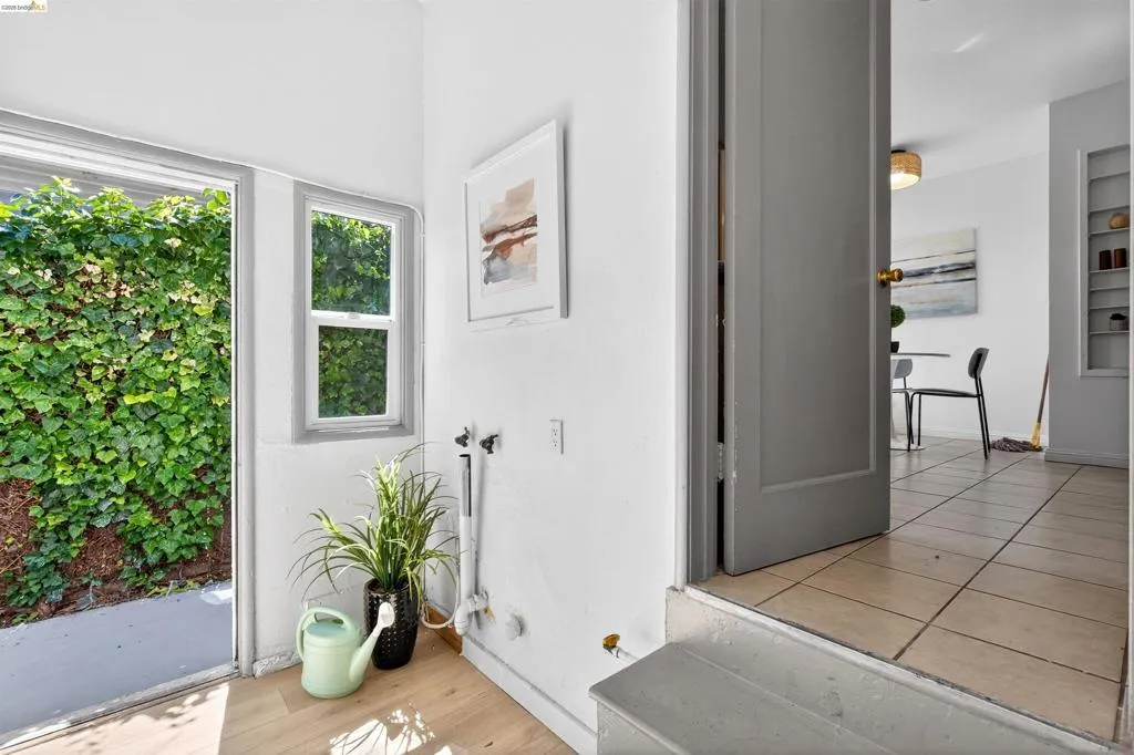 Laundry area with wood-finish flooring and direct outdoor access
