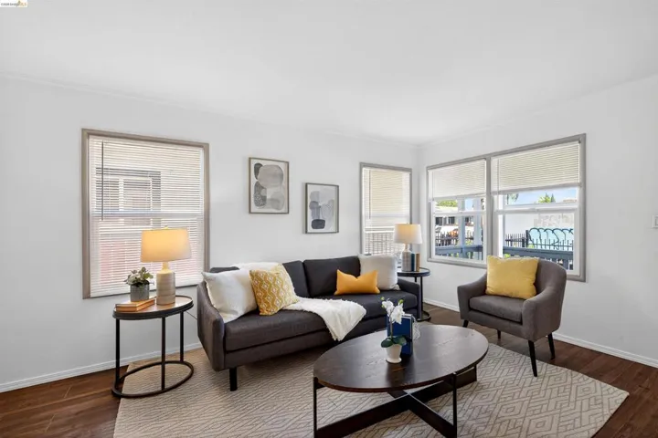 Living area featuring wood-finish flooring and white walls