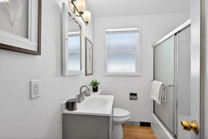 Bathroom featuring a single vanity with under-sink storage, a white basin, and brushed nickel faucet