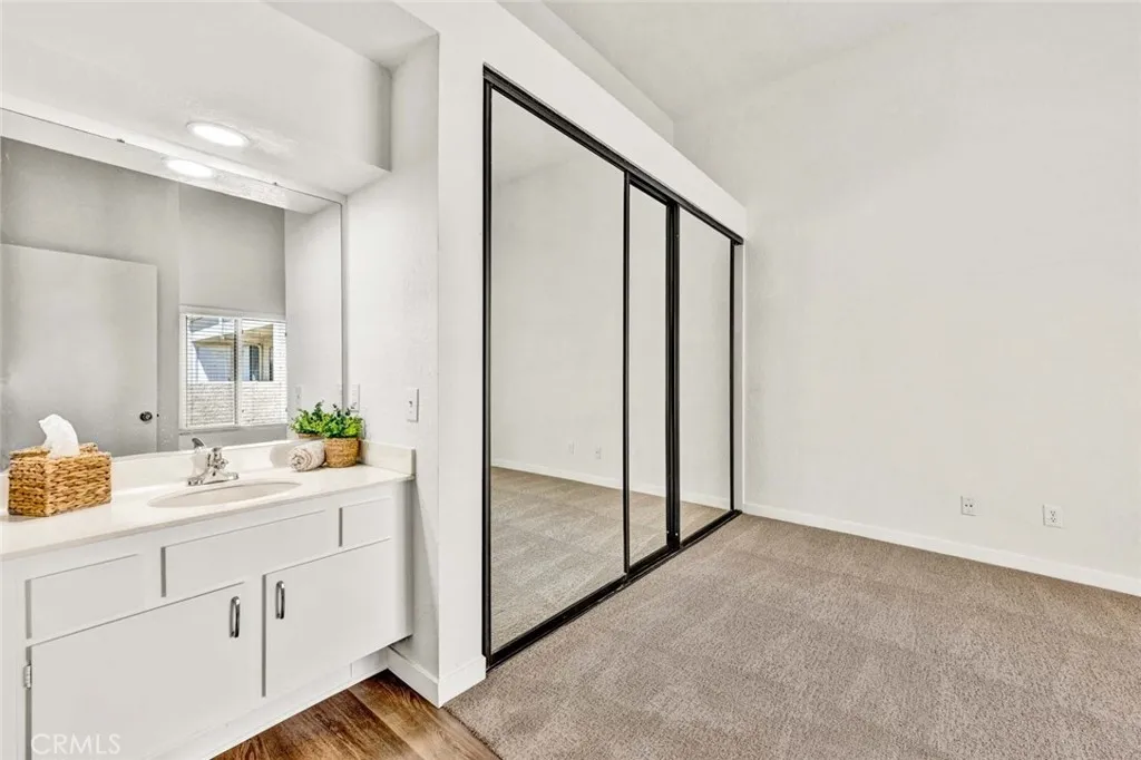 Primary bedroom with new carpet and mirrored closet doors