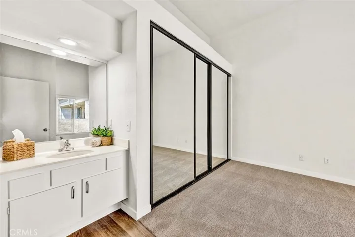 Primary bedroom with new carpet and mirrored closet doors