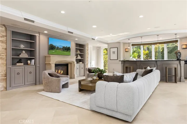 Great Room with fireplace, Built in Bar and direct access to backyard and pool/spa