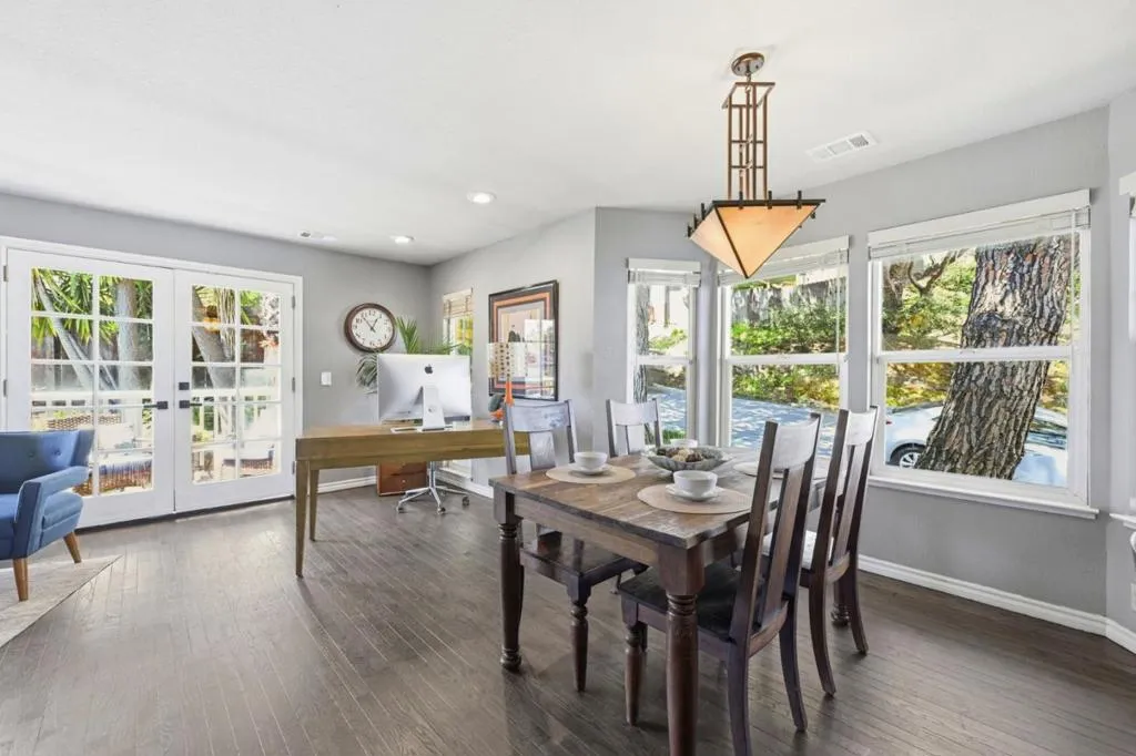 Dining area with corner desk and access to outdoor deck through the french doors. Dining area with corner desk and access to outdoor deck through the french doors.