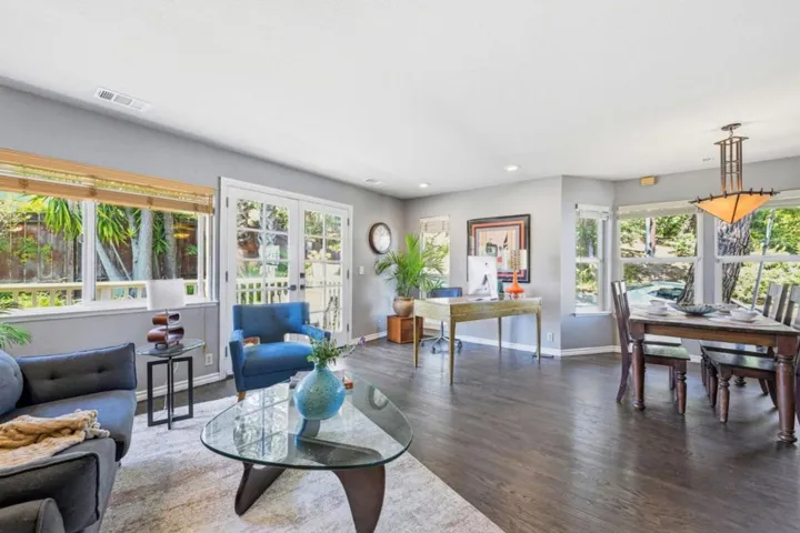 Livingroom//Dining Area with corner office space and French Doors to outdoor deck.