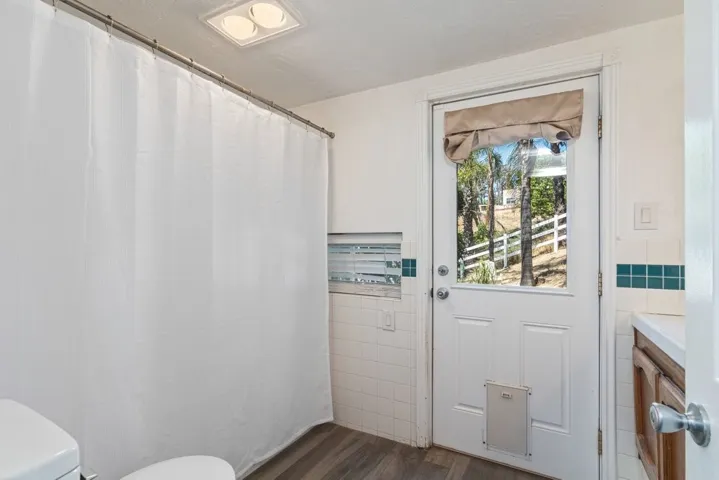 Suite bathroom with door outside by pool