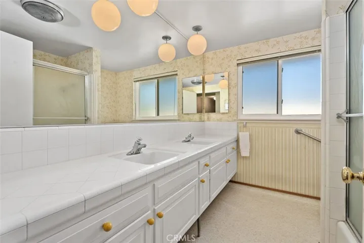 The hall bath has dual sinks for convenience.