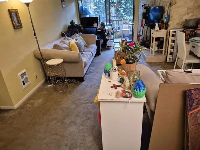 Living area with carpet flooring and light-toned walls