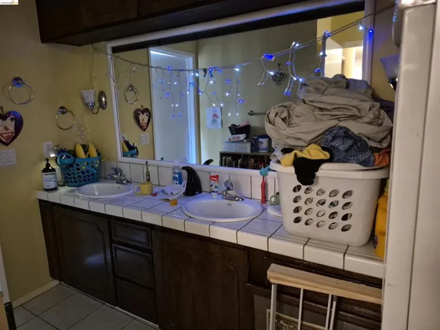 Double vanity with integrated sinks and ceramic tile countertop