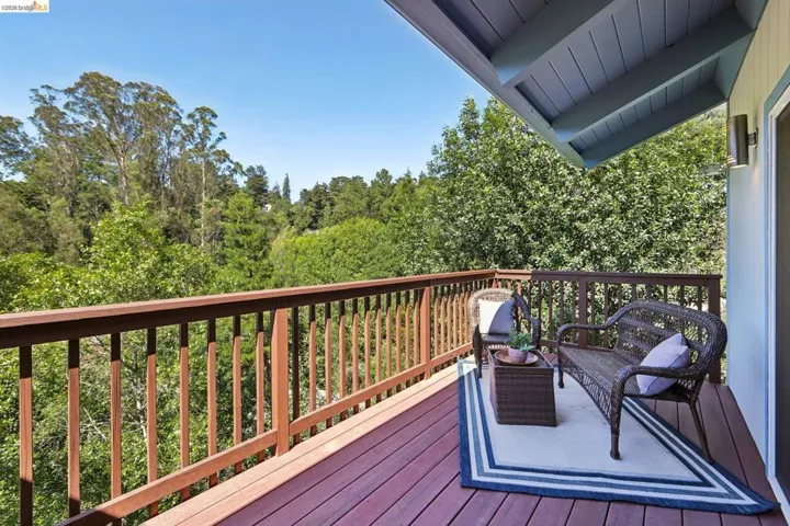 Expansive wooden deck featuring dark-stained wood-finish decking and railings