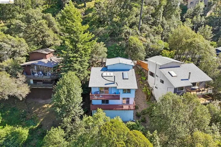 Hillside property featuring a multi-level structure with prominent balconies