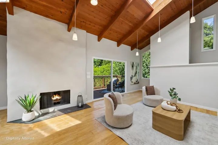 Spacious interior featuring wood-finish flooring and a stone-hearth fireplace