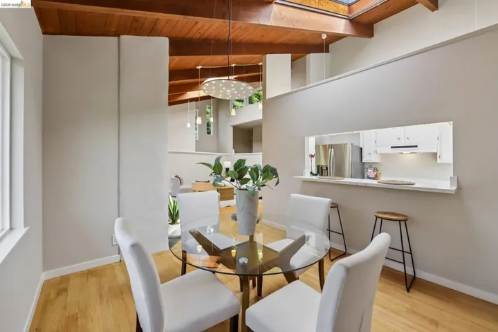 Vaulted wood-finish ceilings with exposed beams and skylights complement the wood-finish flooring