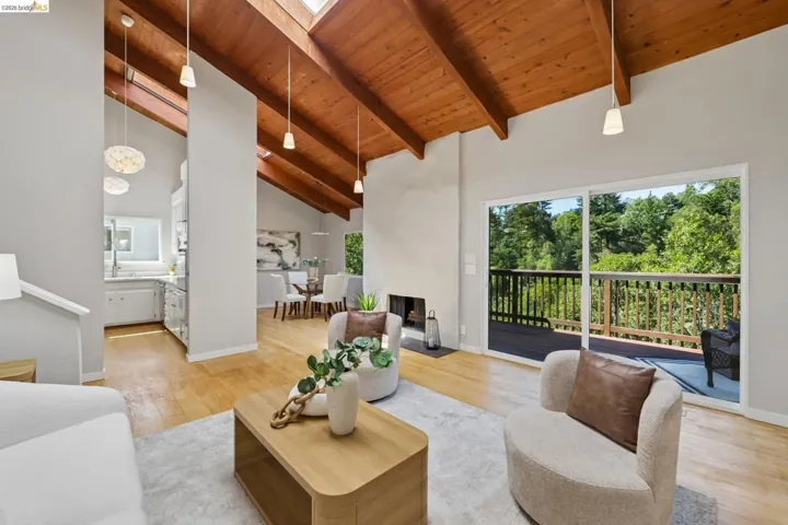Vaulted wood-paneled ceilings with exposed beams and skylights complement the wood-finish flooring