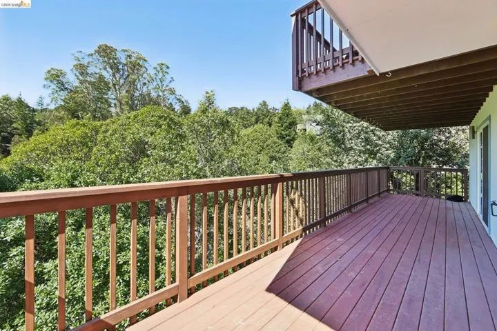 Expansive wood-finish deck with a full-height railing system
