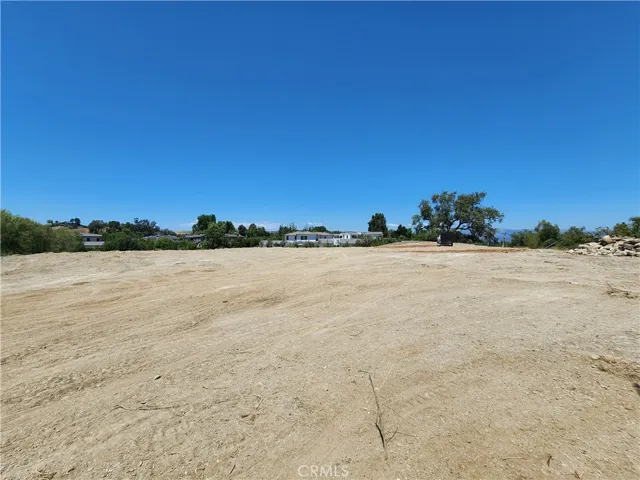 Looking across the center of the building pad towards a home at the end of Hidden Ridge Road.
