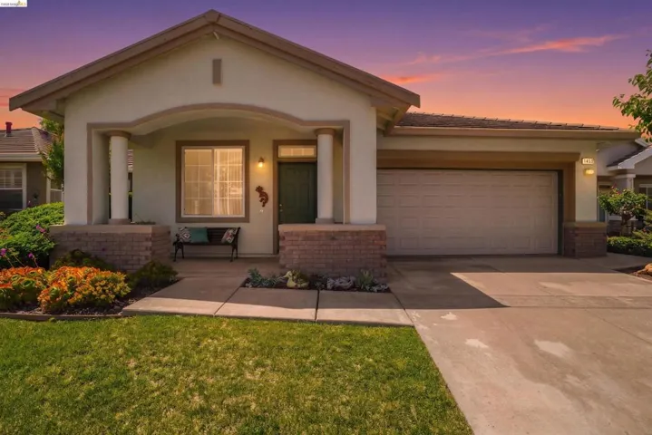 Stucco exterior with brick accents and a covered entry